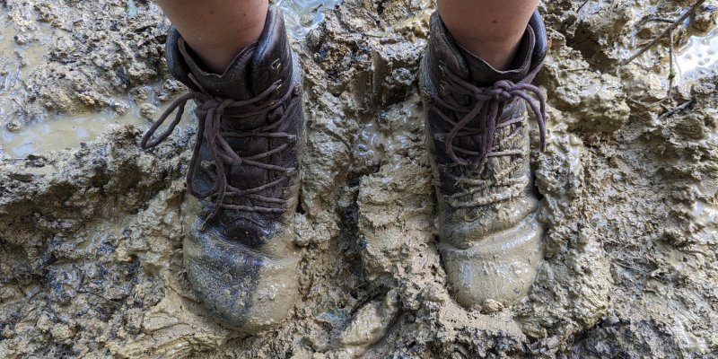 my legs and vivo boots standing in mud